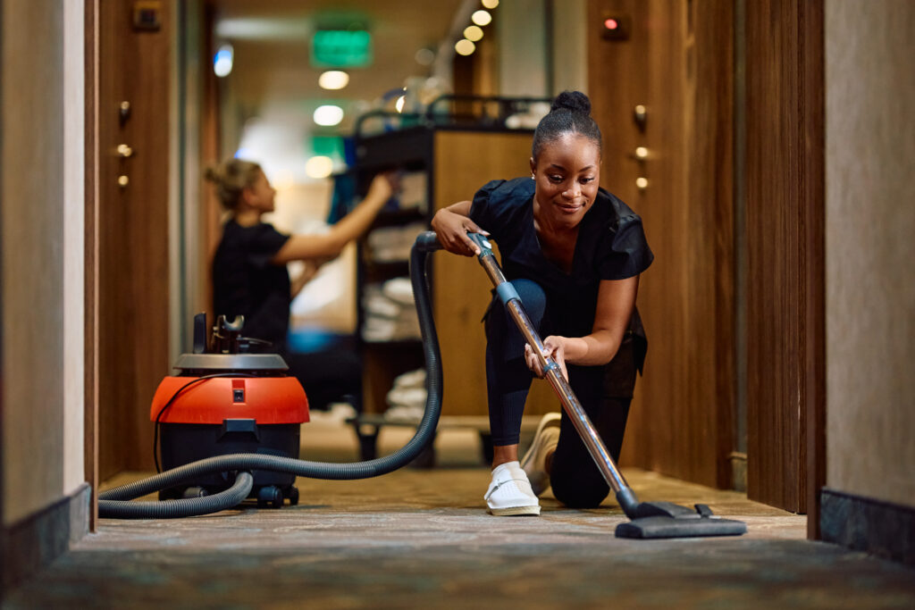 Cropped view of an African American child spraying cleaner, illustrating the health benefits of carpet cleaning by reducing allergens, dust, and improving indoor air quality.