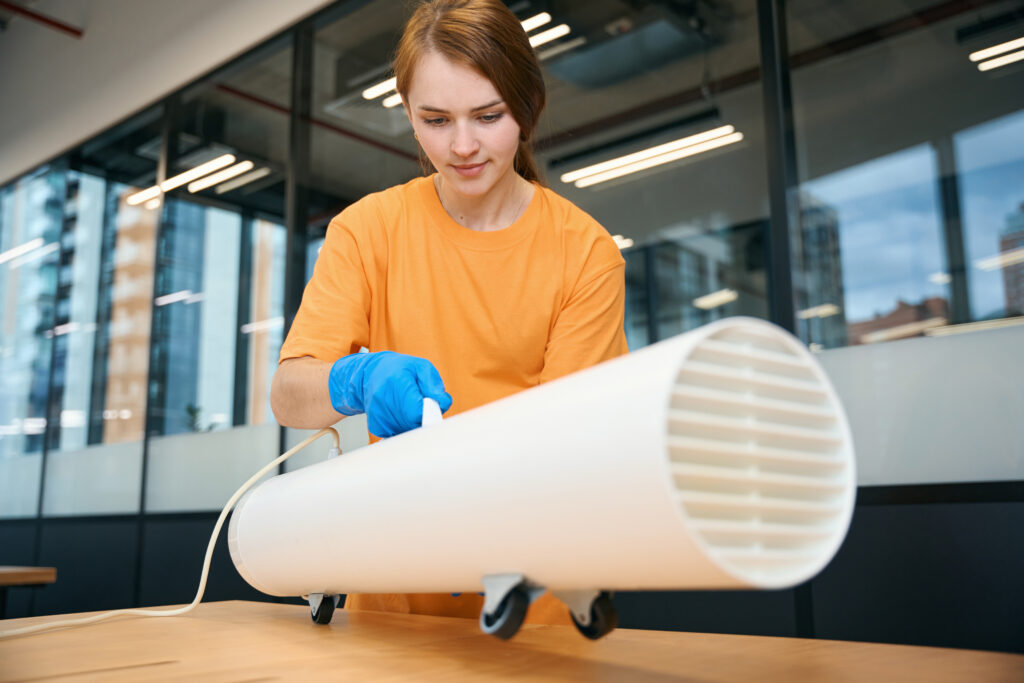 woman inspecting a duct to prepare for air duct cleaning