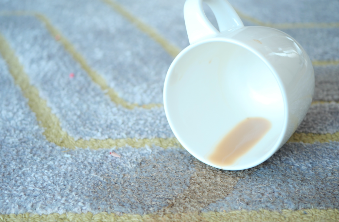 Spilled cup of coffee which begs the question Carpet Cleaning vs. Replacement