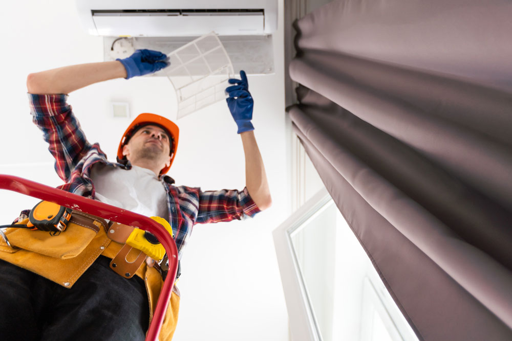 handyman busy doing Air Duct Cleaning Aurora IL